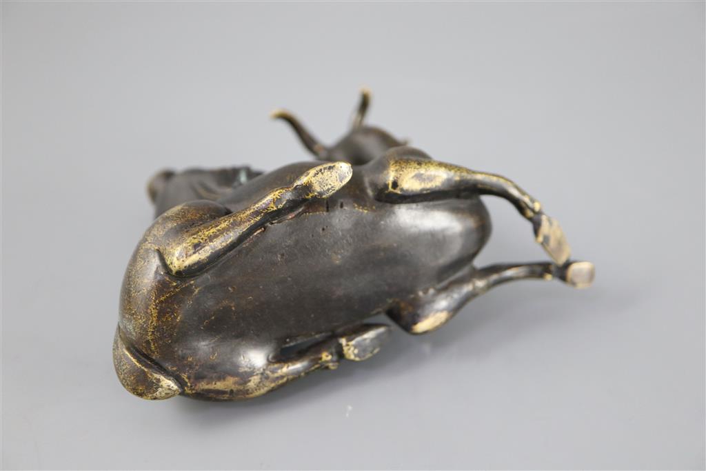 A Chinese late Ming bronze group of an immortal seated on a recumbent deer, 12.5cm long